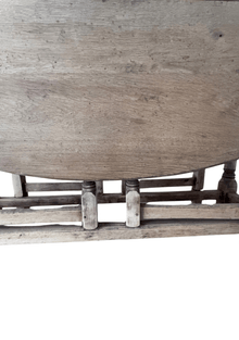 Extreme close-up of the underside stretcher joinery, showing turned peg legs and visible wood grain texture