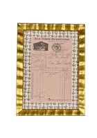 Framed antique French handwritten receipt from Aux Trois Quartiers with a rose block-print fleur-de-lis mat, in a gilt frame