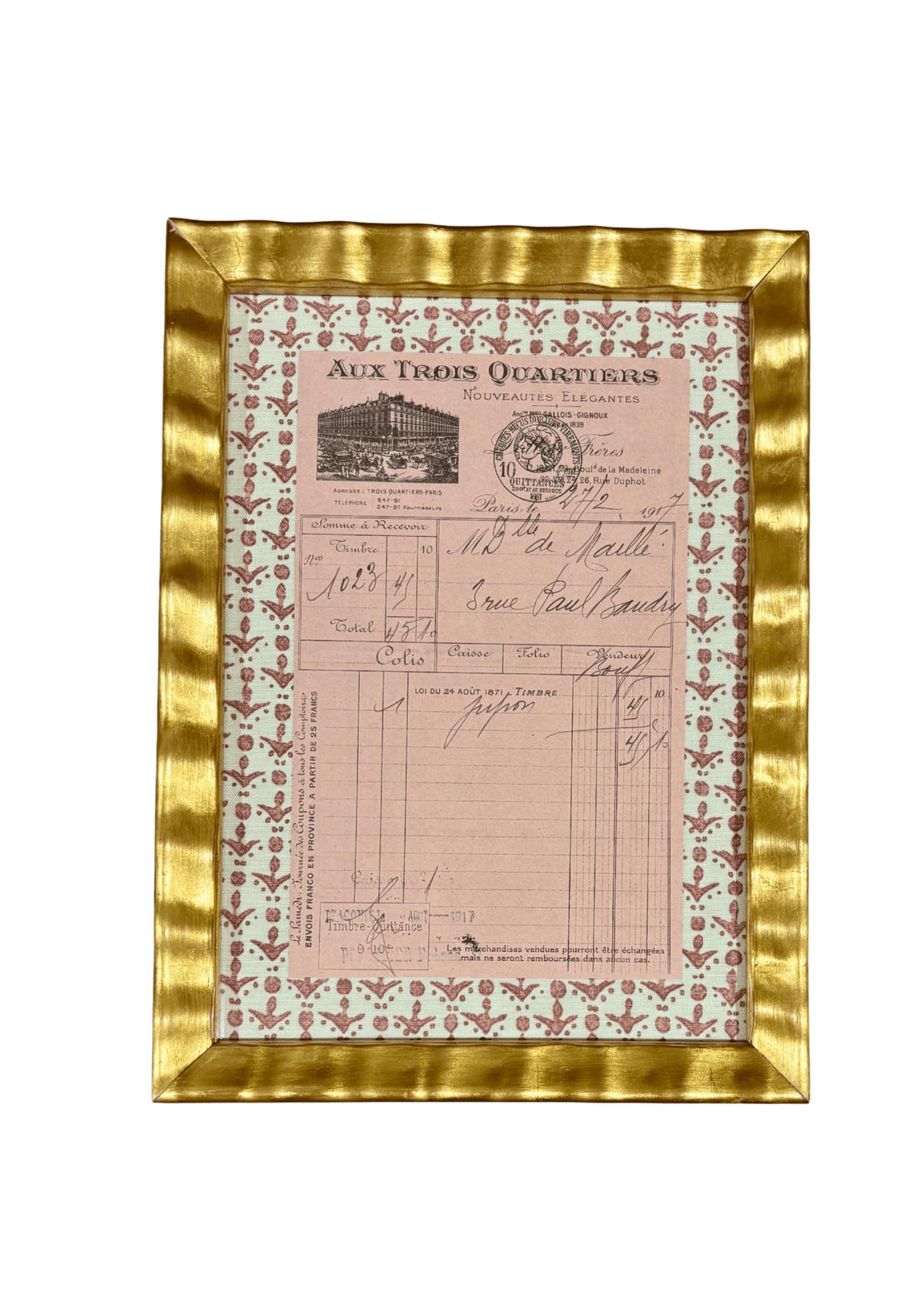 Framed antique French handwritten receipt from Aux Trois Quartiers with a rose block-print fleur-de-lis mat, in a gilt frame