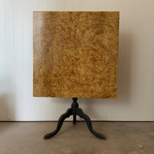 Bleached burl wood tilt-top table with a black cabriole tripod base, top upright