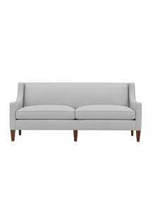 Quick Ship Kenilworth sofa with slope arms, two seat cushions, and tapered wood legs, upholstered in light gray fabric, against a white background.