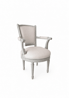 Vintage French swivel desk chair with a round upholstered seat, linen back cushion, and gray-painted fluted legs